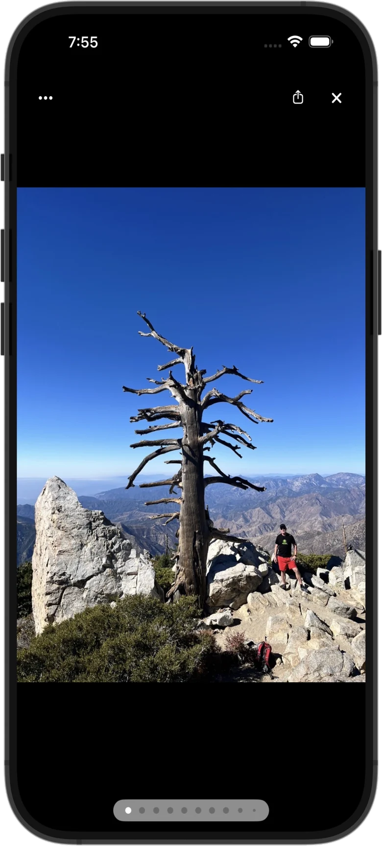 PeakDork iPhone screenshot — a summit photo open full screen in the photo viewer